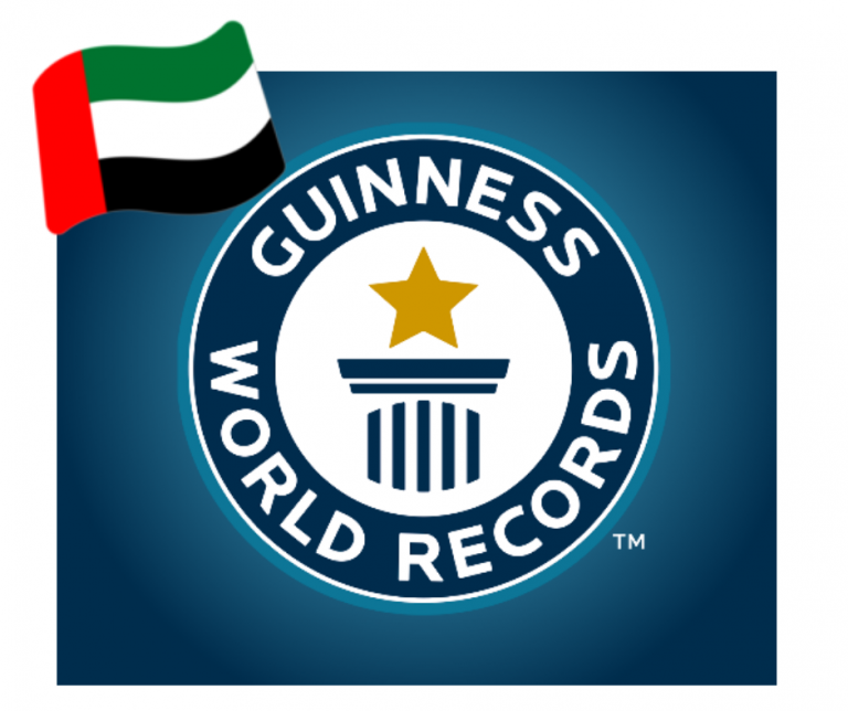 A flag with a vertical stripe and horizontal green, white and black stripes overlaps A logo with text that reads as Guinness World Records and a pictogram with a star atop a pillar