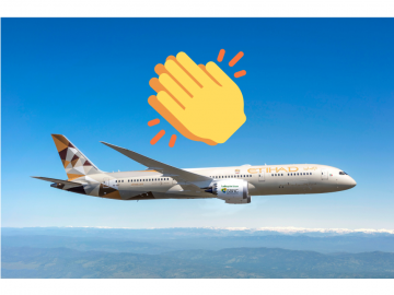 An Aeroplane flyin in blue sky with the word Etihad written on it