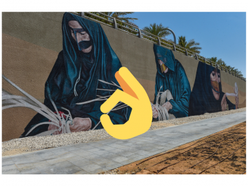 A Wall painted with murals showing women wearing burqa and handcrafting baskets
